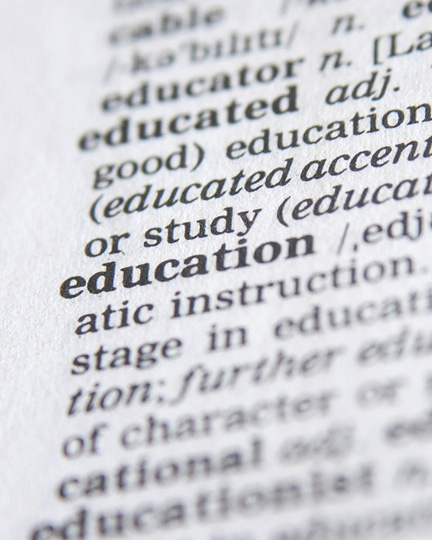 A close up of a dictionary definition focusing on education definition.